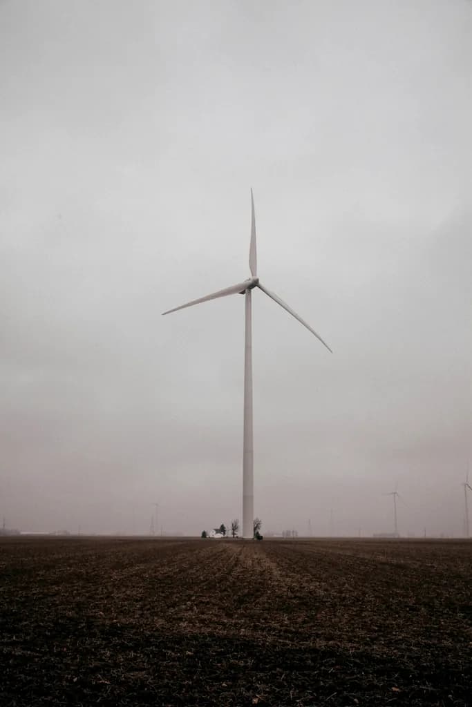 Wind turbine standing in an open field