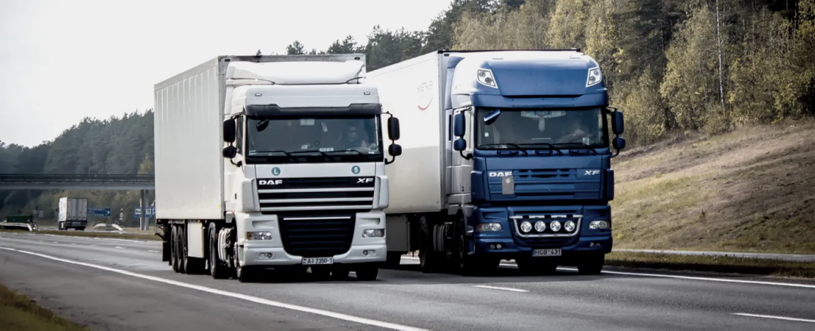 Trucks hauling containerized cargo on the highway